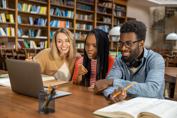 Students studying in the library and looking involved