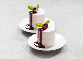 Modern dessert. Cherry Cream pudding, Panna Cotta with cherry sauce. Close-up