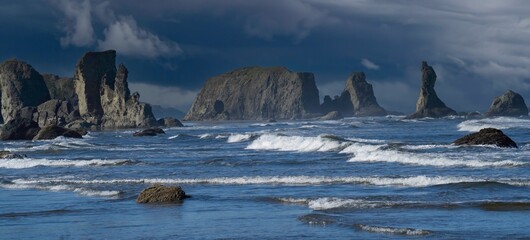 Sea stacks along the Pacific coast at Bandon, Oregon, shot in day time with blue sky.