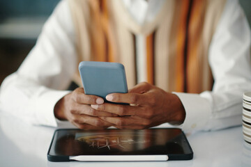 Closeup image of engineer checking notifications on smartphone