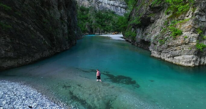 A young man crossing the waters of Shala river Canyon in Shkoder, northern Albania