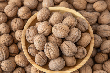 Walnut in shell. Background view from above. Healthy food bowl top view