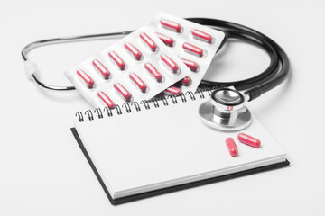 stethoscope equipment and psychotherapy pills modern capsule pink healthy on notebook