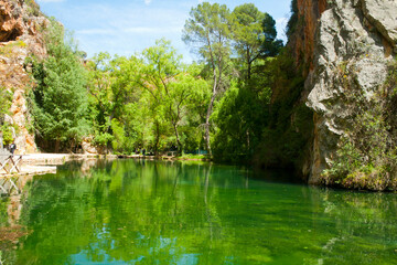 lake with greenish waters at the bottom of a limestone canyon in the area known as stone monastery