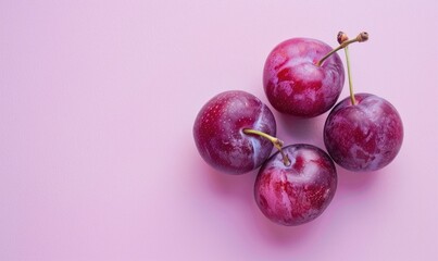 Fresh plums on a pastel lavender background