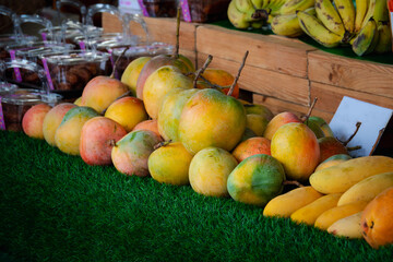 A pile of fruit including  apples mango