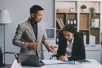 Manager is hard talking with employee in an office. Businessmen arguing at workplace, disagreeing over document, partners having conflict while negotiating, business deal failure