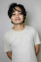 portrait of an Asian Indonesian man posing with random expressions on an isolated white background...