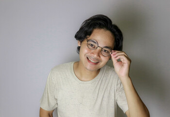 portrait of an Asian Indonesian man posing with random expressions on an isolated white background...