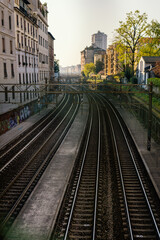 Fototapeta premium Railway tracks running through a populated city