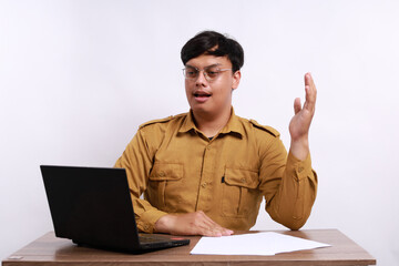 Male teacher in civil servant uniform with hand gestures during online meeting using a laptop