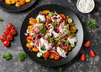 Warm greek potatoes salad with green lentils, tzatziki, tomatoes, cucumbers and kalamata olives.