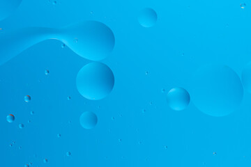 Abstract image with blue bubbles on a light blue gradient background.