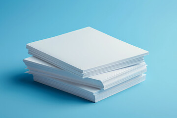 Stacked white sheets of paper on a blue blank background, top view
