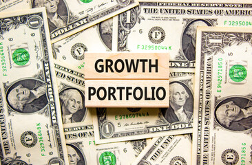 Growth portfolio symbol. Concept words Growth portfolio on beautiful wooden block. Beautiful dollar bills background. Dollar bills. Business Growth portfolio concept. Copy space.