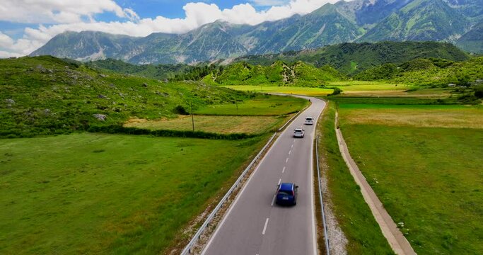 Aerial view of cars driving over a  road going through Vlora countryside in the southern Albania. 