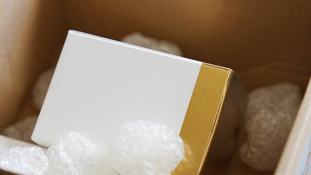 Eco packaging of parcels and white biodegradable filler. Box is filled with a filler safety for environment. Delivery of goods, parcels, delivery service, nature protection and recycling concept