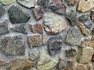Green plants in front of stone wall exterior background outdoor natural setting