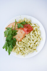Fried chicken meat with a side dish of pasta. Delicious meat breakfast.