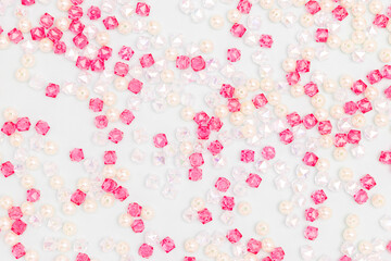 Texture made from shiny acrylic beads scattered on a blue background.