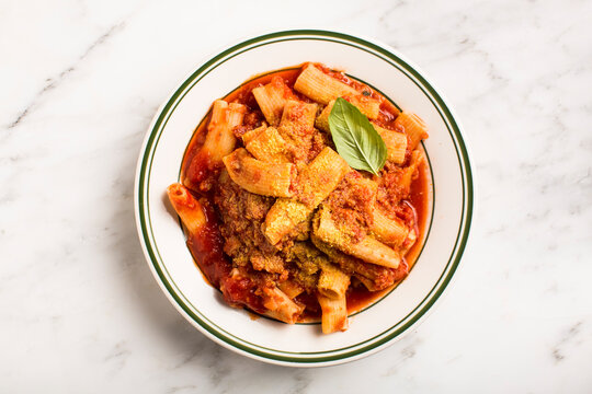 Overhead of plate of pasta on marble surface