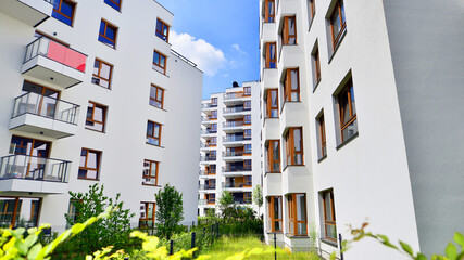European residential architecture harmonizing with nature. Eco-friendly living in city with greens. Eco apartment building saving energy and fresh air concept. 