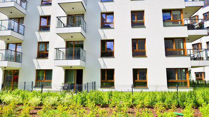 European residential architecture harmonizing with nature. Eco-friendly living in city with greens. Eco apartment building saving energy and fresh air concept. 