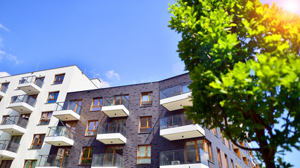 European residential architecture harmonizing with nature. Eco-friendly living in city with greens. Eco apartment building saving energy and fresh air concept. 