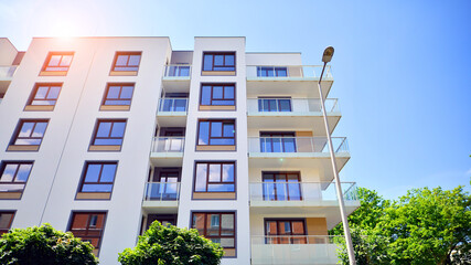 European residential architecture harmonizing with nature. Eco-friendly living in city with greens. Eco apartment building saving energy and fresh air concept. 