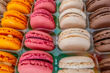 French macaroons in rows in packaging from a shop