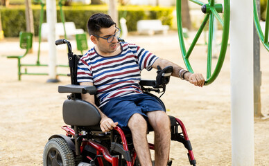 A 40-year-old disabled adult male is sitting in an automatic wheelchair.The disabled man is...