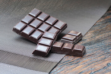 Dark chocolate. Broken chocolate bar on kitchen table