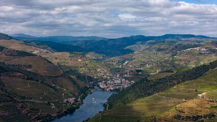Naklejka premium View of the terraced vineyards in the Douro Valley and river near the village of Pinhao, Portugal. Concept for travel in Portugal and most beautiful places in Portugal