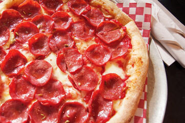 Crispy pizza pepperoni close-up