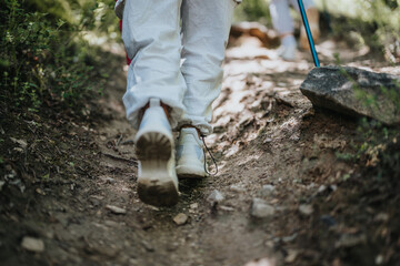 Close-up shot of hikers walking on a forest trail, highlighting the adventure, exploration, and connection with nature.