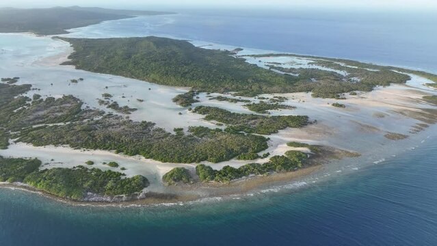 Sunlight shines on the scenic coast of a remote island, Pulau Selu, in the Tanimbar Islands of Indonesia. This tropical area harbors beautiful coral reefs and a wide diversity of fishes.