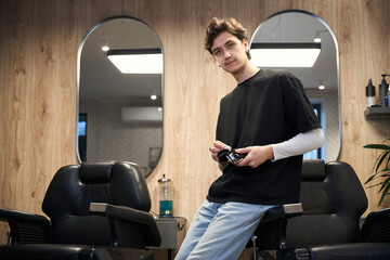Diligent hairstylist working in modern hairdressing salon