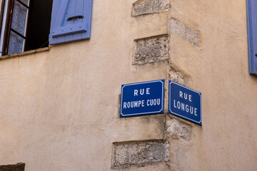 old fashioned French street plaques with names saying "reckless street" and "long street"