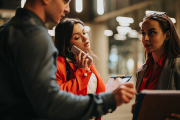 Young corporate business partners engaged in discussion in a modern office environment. Teamwork and collaboration in a professional setting.