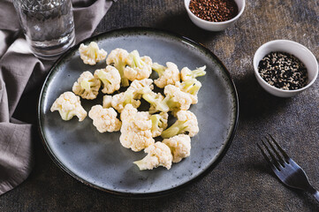 Vegetarian vegetable raw cauliflower on a plate on the table