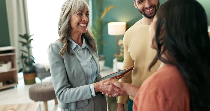 Couple, real estate and handshake with tablet in new home with smile for property and ownership. People, realtor and happy customer or client with agreement on deal for house sale or purchase