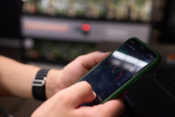 A person is using a smartphone in the office for work and communication, embracing the digital age