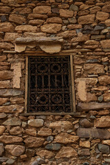 door of an old castle and architecture of stones buildings in a village in the south of the Kingdom of Morocco in the Souss-Massa region