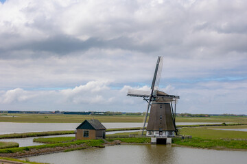 Traditional Molen Het Noorden (Windmills The North) A Dutch polder mill, Spring landscape with flat...