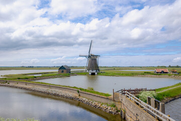 Traditional Molen Het Noorden (Windmills The North) A Dutch polder mill, Spring landscape with flat...