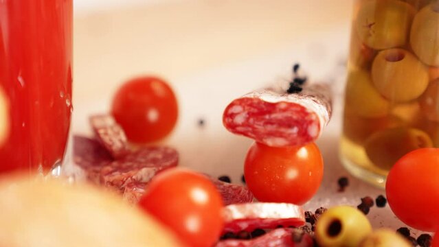 Spanish fuet smoked sausage, ciabatta, cherry tomatoes, olives. Spanish Italian breakfast, Mediterranean delicacies