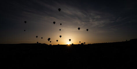 Landscape sunrise or sunset in Cappadocia with set hot air balloon fly in sky. Concept tourist travel Goreme Turkey.