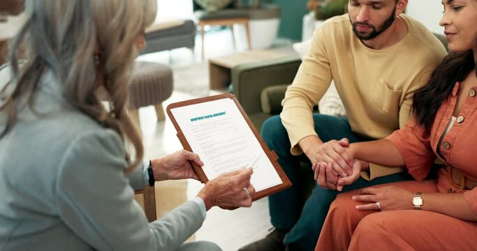 Therapist, clipboard and couple holding hands on sofa for signature or advice, communication or emotional support in office. Meeting, help and people for discussion, information or guidance service