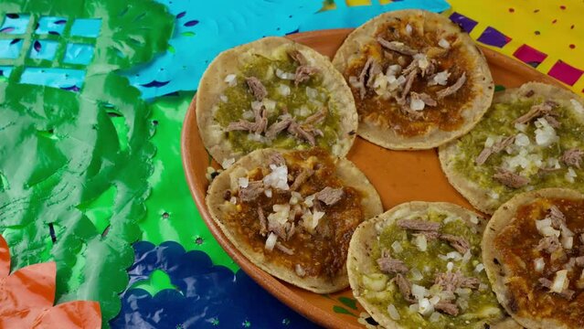 Chalupas with Mexican party decoration close up, travel shot left