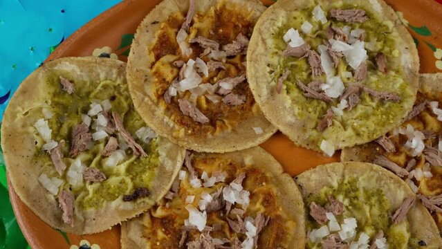 Small corn tortilla chalupas with green and red spicy sauce and a Mexico flag, Dolly